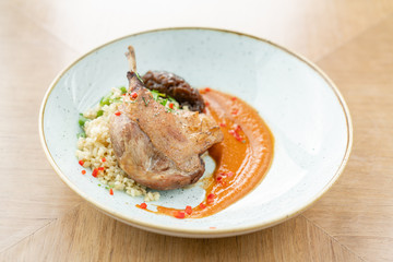 Plate Duck leg su-vide, with bulgur and onion marmalade. Barbecue restaurant menu, a series of photos of different meats