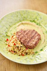 Plate with Beefsteak marbled beef, served with bulgur and smoked onion cream. Barbecue restaurant menu, a series of photos of different meats