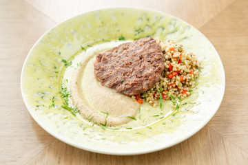 Plate with Beefsteak marbled beef, served with bulgur and smoked onion cream. Barbecue restaurant menu, a series of photos of different meats