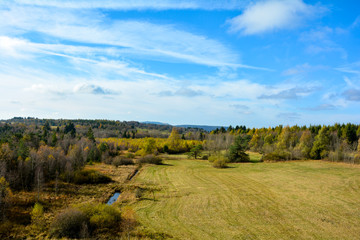 Green landscape from above, with big meadow, waters, trees and blue sky in  Germany