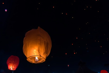 Close-up lantern with thousand lanterns fly in the beautiful sky in the background at night