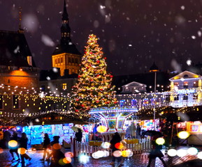 Christmas city market place in Tallinn town Hall Square, Illuminated tree,night light blurred...