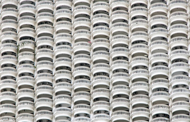 The Facade of a high-rise house with many half-round balconies. Line of circular balconies on white...