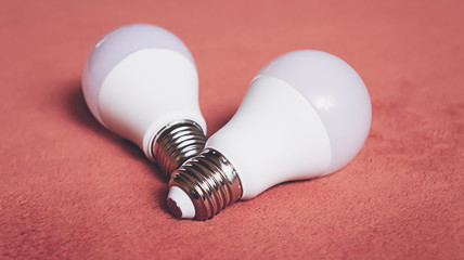 Light bulbs on a soft fluffy peach-colored background
