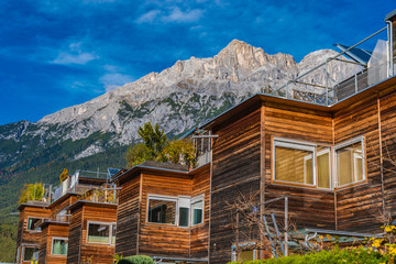 Obraz na płótnie Canvas residential building with wooden facades in the mountains, telfs, st. wendelin, tyrol, austria
