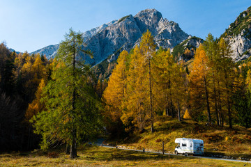 Driving caravan on a mountain road in Slovenia in fall - obrazy, fototapety, plakaty