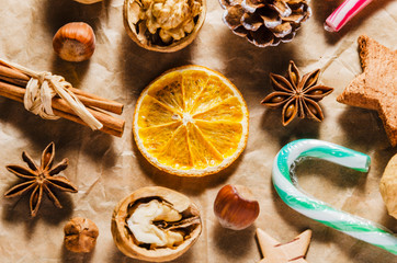 variety of christmas food products ginger cake nuts cinnamon stick lollipop on paper