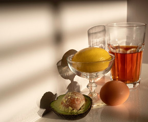 Avocado, egg, lemon and tea for healthy breakfast. Natural food.