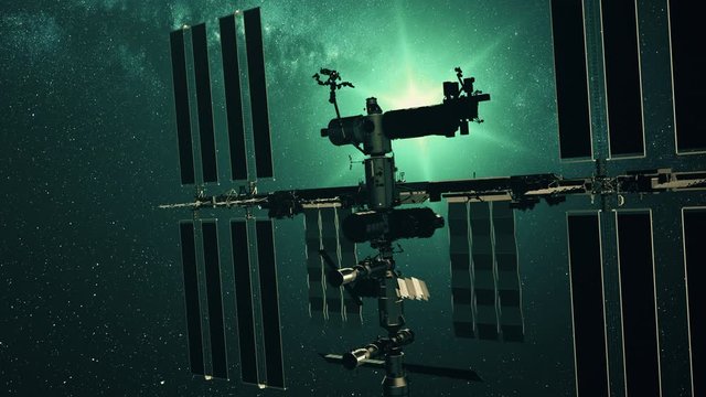 International Space Station charging solar battery. Pan right of realistic ISS with array. Star twinkle view from outer cosmos. 3d render animation. 4K. Elements of this media furnished by NASA