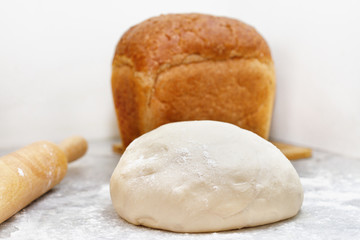 one bun of baked brown bread stand on the table
