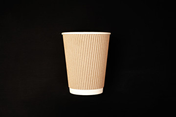 Paper coffee cup on black background. Mock up mug