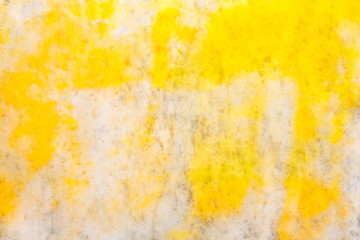 Bright yellow paint on a marble wall, texture, background