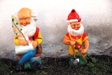 Funny little gnome man stand in the garden