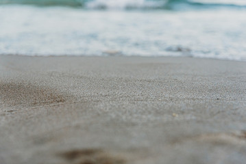 Nostalgic background of fine sand with unfocused background.