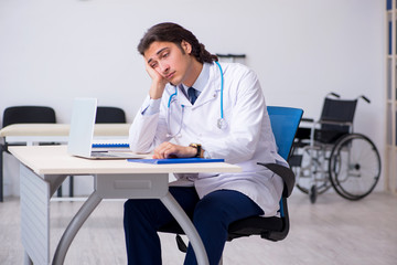 Young doctor being tired after night shift