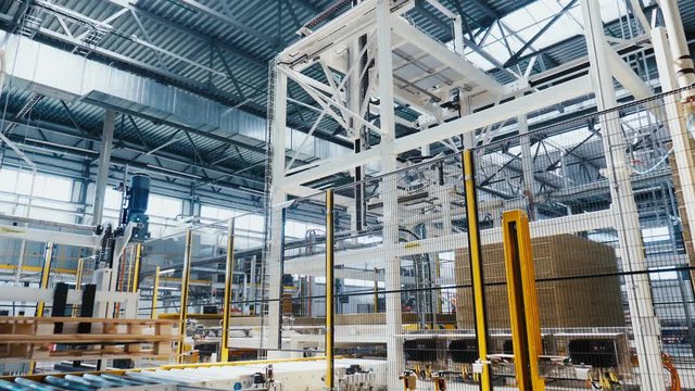 machine takes stone thermal insulation from pile in shop