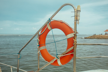 Red Lifebuoy on the ship In the tropical sea