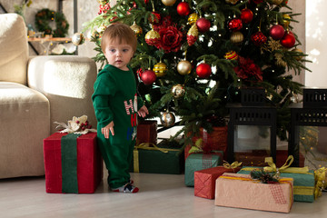 little smiling boy with christmas gift box. Merry Christmas and Happy Holidays