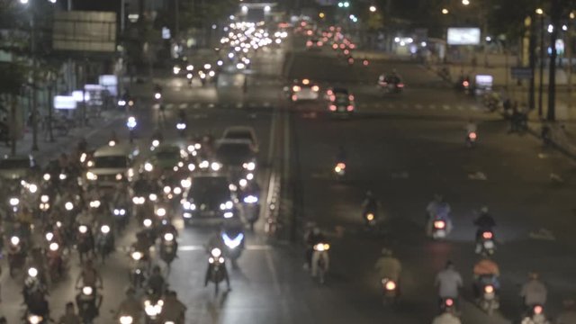 Blurred footage of transport in Ho Chi Minh. Travel in Ho Chi Minh city by a motorbike. Royalty high-quality free stock footage of slow moving traffic with lots of motorbike, bus, car in night city