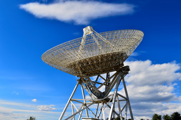 Array of satellite dishes or radio antennas against sky. Space o
