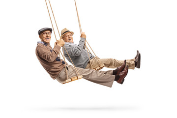 Two elderly gentleman swinging and smiling