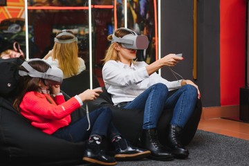 Obraz na płótnie Canvas Mother and child playing together with virtual reality headsets