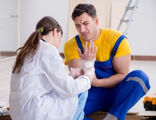 Injured worker being assisted by doctor