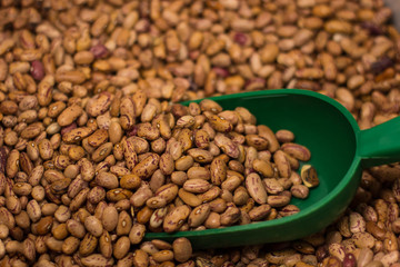 raw beans vegetarian food background market counter with spoon by weight 