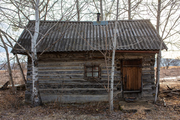 Fototapeta na wymiar Russian village. Old wooden shed on the ground in a Russian village.
