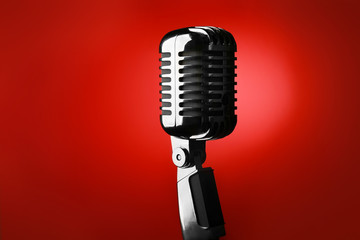 Retro microphone on color background