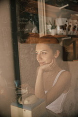 Beautiful girl drinks aromatic coffee inside in a restaurant