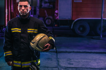 Fototapeta premium Portrait of a firefighter with uniform inside the fire station