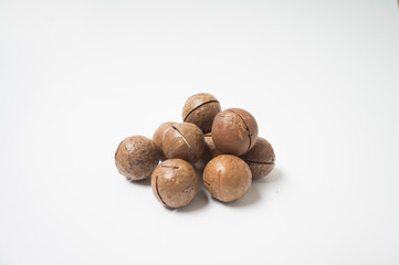 Macadamia nuts on white background.