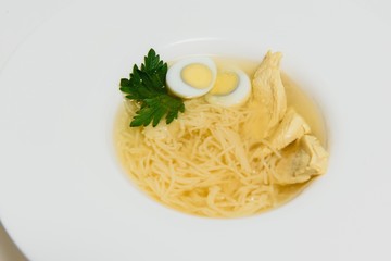 Bowl of chicken broth isolated on white background