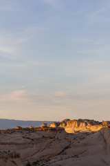 Desert Landscape at Sunset with Illuminated Rock Formation
