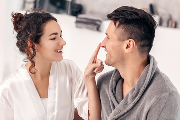 Happy young couple in bathroom at home