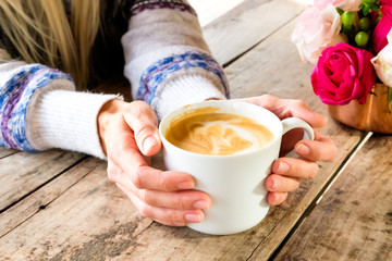 Cup of coffee in hands.