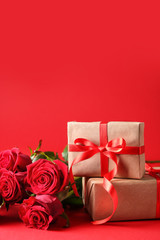 Gift for Valentine's Day and rose flowers on color background