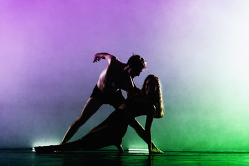 Fototapeta na wymiar Couple of ballet performers exercising in studio