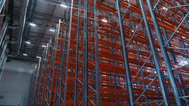 empty metal racks installed in modern spacious storehouse