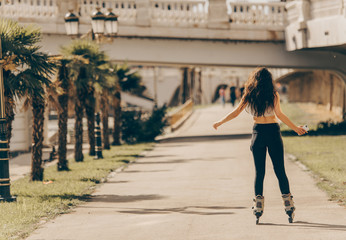 Young woman in the park while rollerblading