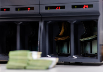 Various types of banknotes being counted by a counting machine