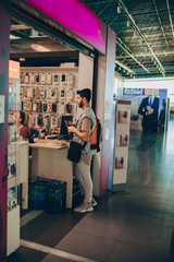 Man with backpack buying stuff for the trip on the airport