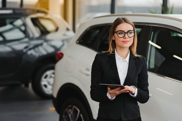 business woman in auto salon. concept of female driver