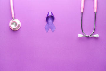 Fototapeta premium Stethoscope and purple ribbon as symbol of World Cancer Day on color background