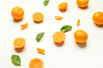 Ripe tasty tangerines on white background