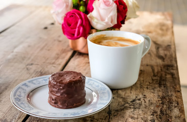 Cup of coffee, cake and flowers.