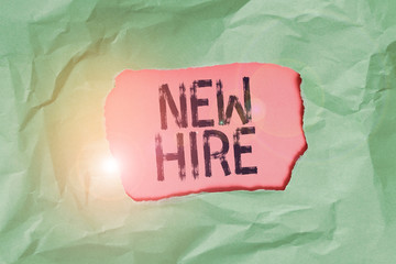Handwriting text New Hire. Conceptual photo someone who has not previously been employed by the organization Green crumpled ripped colored paper sheet centre torn colorful background