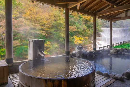 Japanese Hot Springs Onsen Natural Bath Surrounded by red-yellow leaves. In fall leaves fall in Fukushima, Japan.