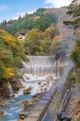 Fototapeta premium Waterfall at Tsuchiyu Onsen in beautiful autumn (fallen leaves) at tohoku, Fukushima, Japan